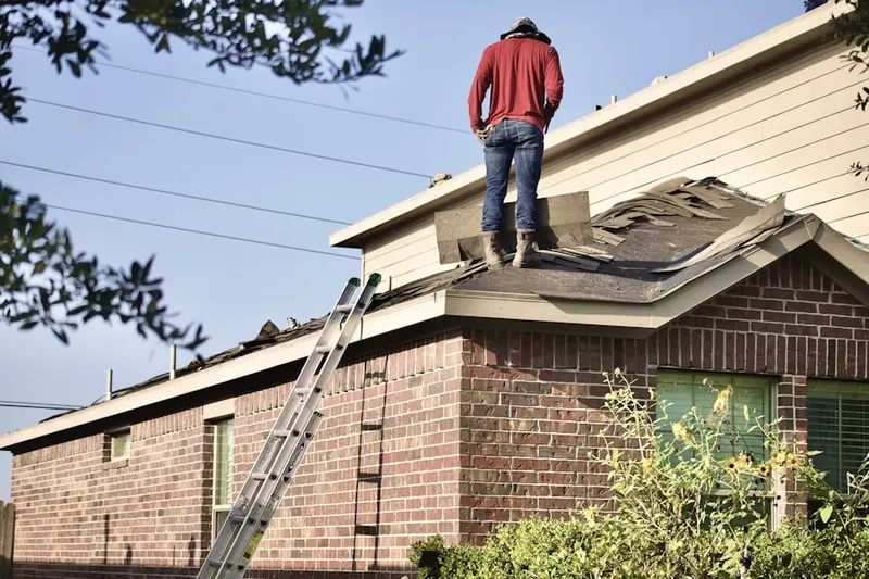 Professional roofer working on a residential roof in River View